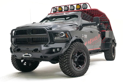 Fab Fours Matrix front bumper with full guard on a gray and black Ram 3500, front passenger-side three-quarter view, showing the tubular grille guard, LED light bar, and center winch