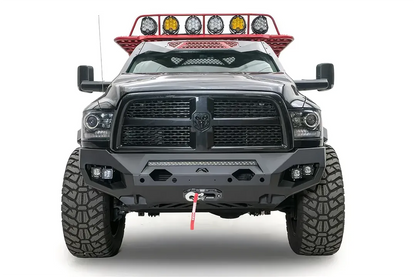 Fab Fours Matrix front bumper on a gray and black Ram 3500, straight-on front view, showing the LED light bar, cube light pods, and winch fairlead