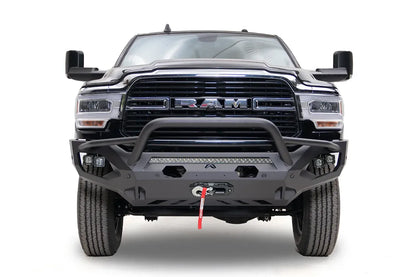 Fab Fours Matrix front bumper with pre-runner guard on a black Ram 2500, straight-on front view, showing the pre-runner bar, LED light bar, and winch fairlead