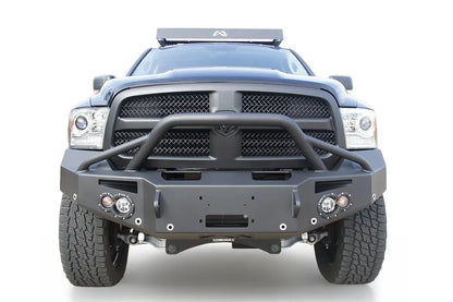 Fab Fours Premium front bumper with pre-runner guard on a black Ram 1500, straight-on front view, showing the pre-runner hoop, winch fairlead opening, round lights and D-ring mounts