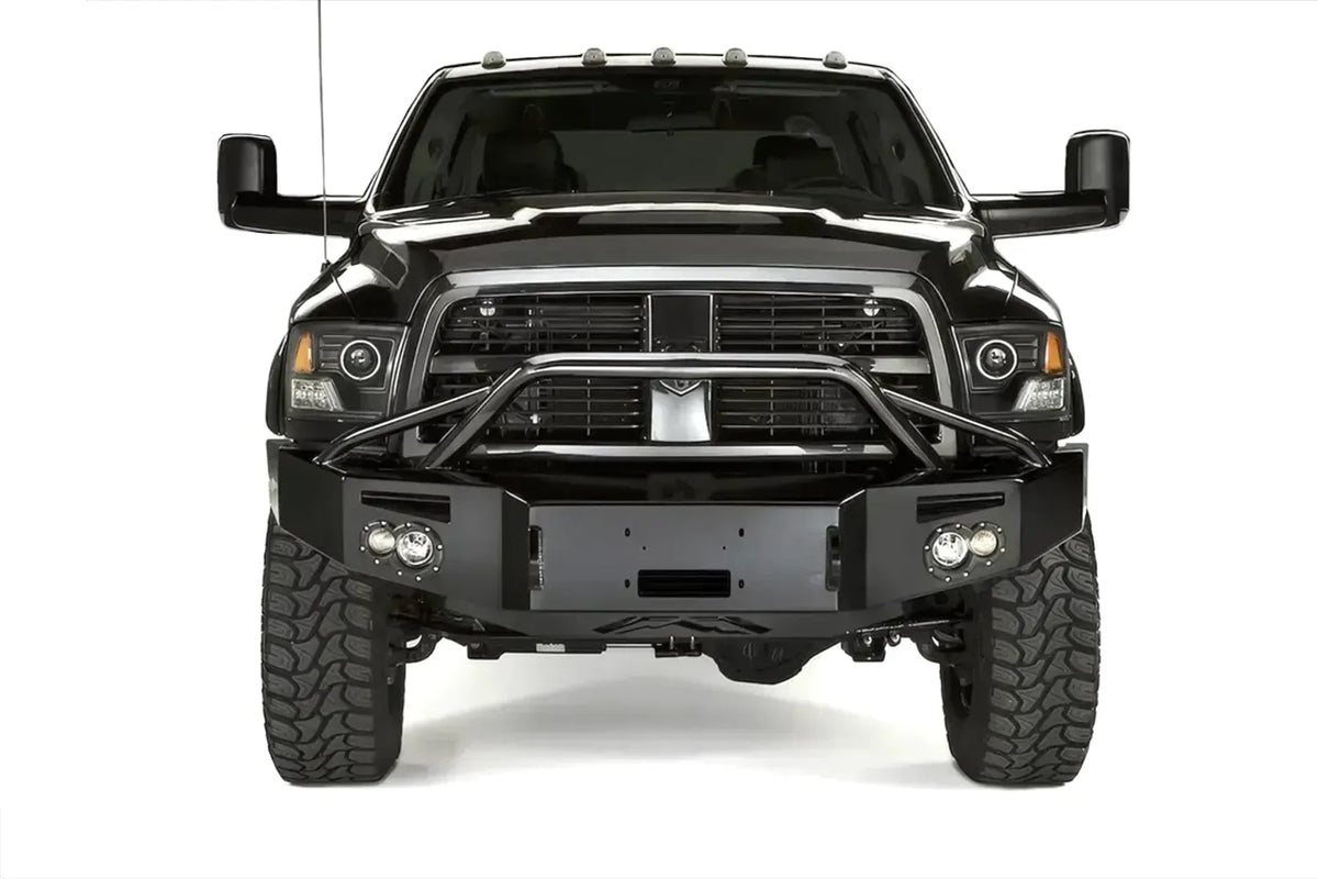 Fab Fours Premium front bumper with pre-runner guard on a black Ram, straight-on front view, showing the pre-runner hoop, winch mount opening, round lights and D-ring mounts