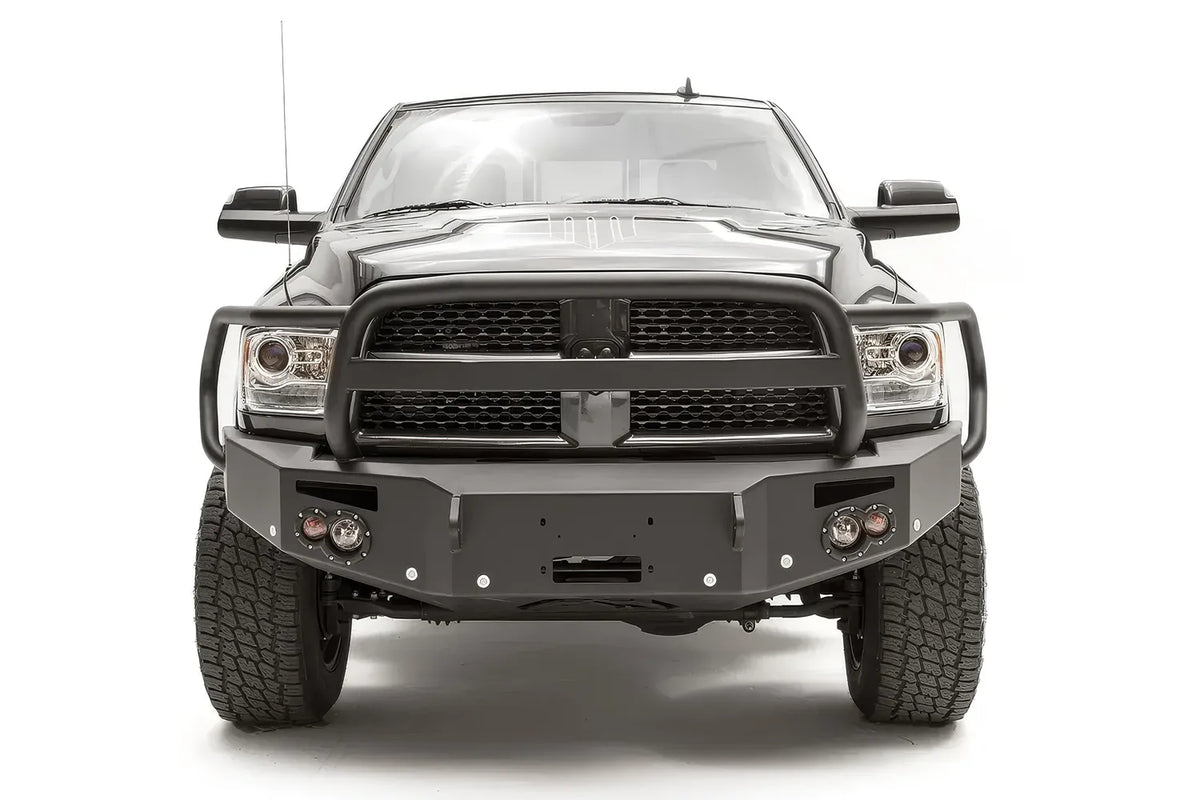 Fab Fours Premium front bumper with full guard on a black Ram 2500, straight-on front view, showing the full grille guard hoop, winch mount opening and round lights