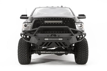 Fab Fours Vengeance front bumper with pre-runner guard on a black lifted Ram 2500, straight-on front view, showing the pre-runner hoop, integrated light bar, cube lights and skid plate