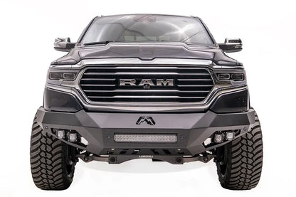 Fab Fours Vengeance front bumper on a dark blue lifted Ram 1500, straight-on front view, showing the integrated light bar, cube light pods and center logo