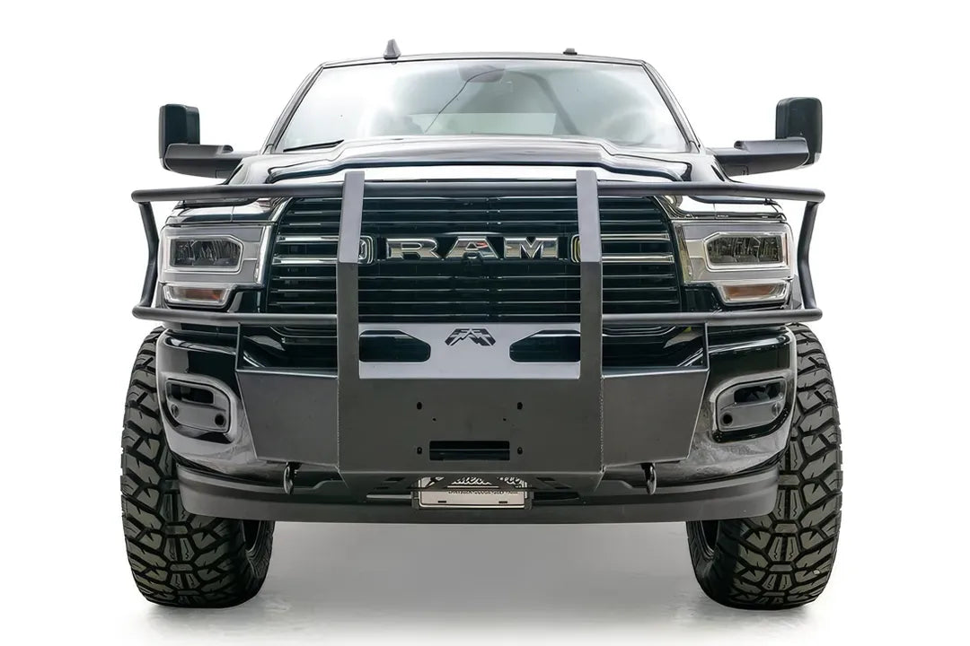 Fab Fours winch mount with full guard on a black lifted Ram 2500, straight-on front view, showing the full guard uprights, wrap-around side bars and winch plate
