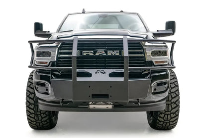 Fab Fours winch mount with full guard on a black lifted Ram 2500, straight-on front view, showing the full guard uprights, wrap-around side bars and winch plate