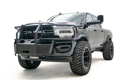 Fab Fours winch mount with full guard on a black lifted Ram 2500, front driver-side three-quarter view, showing the full guard uprights, side bars and winch plate