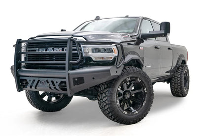 Fab Fours Black Steel Elite front bumper with full guard on a black lifted Ram 2500, front driver-side three-quarter view, showing the full grille guard, slotted skid plate and Elite badge