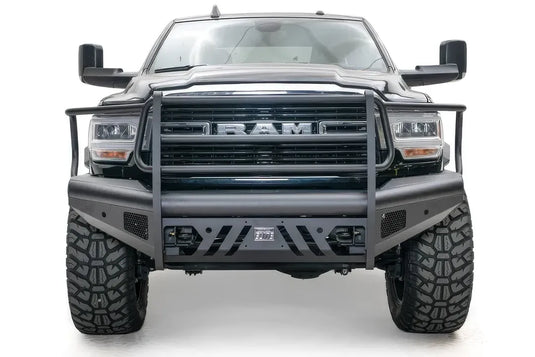 Fab Fours Black Steel Elite front bumper with full guard on a black lifted Ram 2500, straight-on front view, showing the full grille guard, Elite badge and slotted skid plate