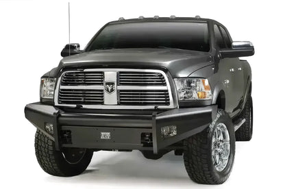 Fab Fours Black Steel Elite front bumper on a gray Ram 2500, front three-quarter view, showing the center tube, Elite badge and mesh-covered light openings