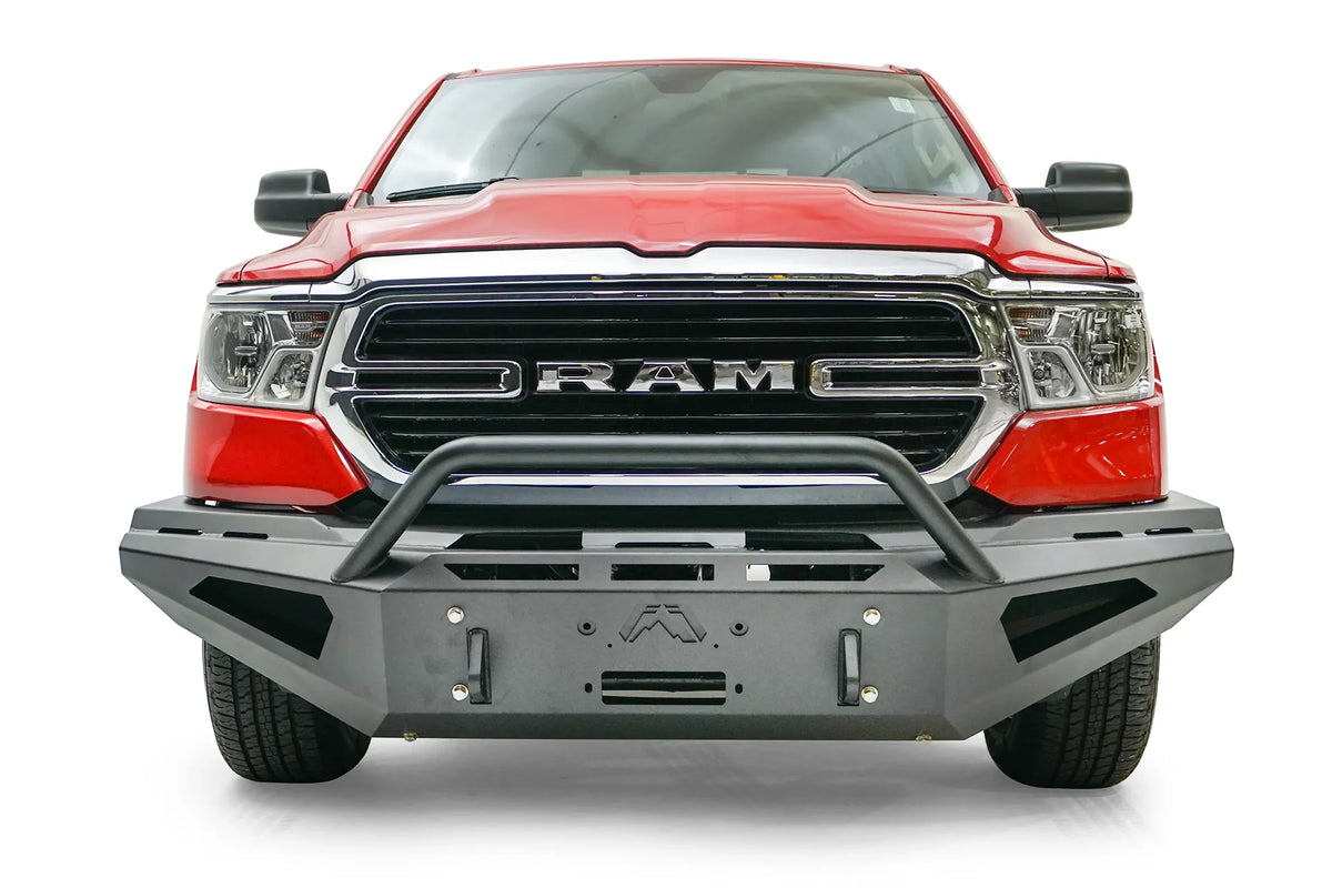 Fab Fours Red Steel front bumper with pre-runner guard on a red Ram 1500, straight-on front view, showing the pre-runner hoop, winch fairlead opening, shackle mounts and vented ends