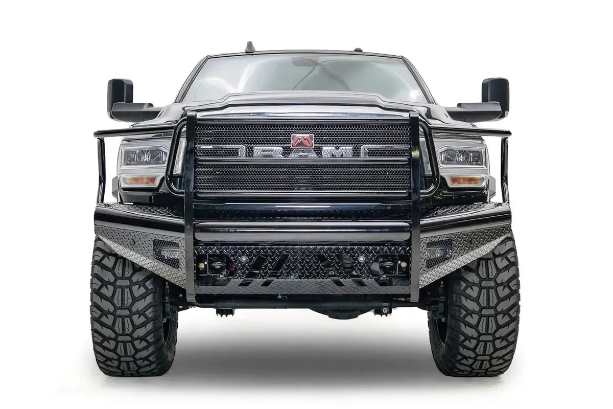 Fab Fours Black Steel front bumper with full guard on a black lifted Ram 2500, straight-on front view, showing the full grille guard, mesh panel and diamond-plate face