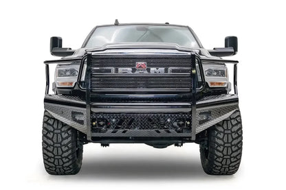 Fab Fours Black Steel front bumper with full guard on a black lifted Ram 2500, straight-on front view, showing the full grille guard, mesh panel and diamond-plate face