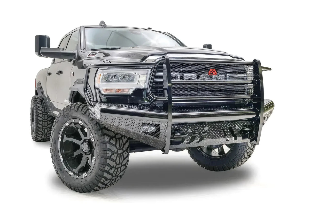 Fab Fours Black Steel front bumper with full guard on a black lifted Ram 2500, front passenger-side three-quarter view, showing the full grille guard, diamond-plate face and side wraps
