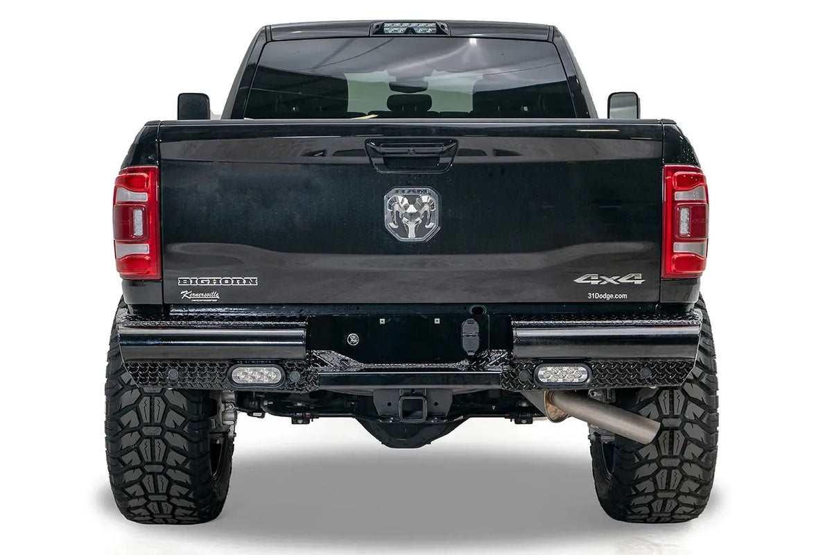 Fab Fours Black Steel rear bumper on a black Ram 2500, straight rear view, with diamond plate face