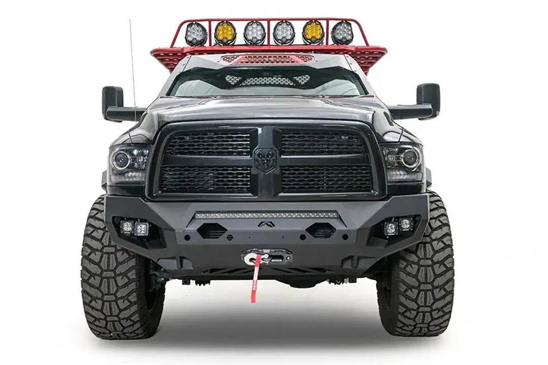 Fab Fours Matrix front bumper on a gray lifted Ram 2500, straight-on front view, showing the integrated light bar, cube light pods and winch