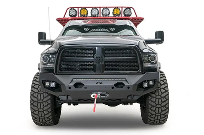 Fab Fours Matrix front bumper on a gray lifted Ram 2500, straight-on front view, showing the integrated light bar, cube light pods and winch
