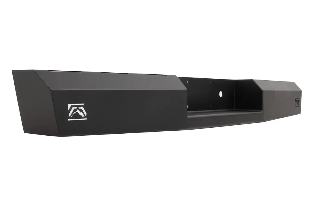 Fab Fours Red Steel rear bumper in black powder coat, opposite angled rear view, showing the logo end cutout, plate pocket and faceted end cap