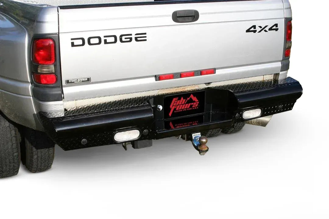 Fab Fours Black Steel Ranch rear bumper with diamond plate on a silver Dodge Ram dually, rear three-quarter view