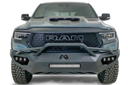 Fab Fours Vengeance front bumper with pre-runner guard on a gray Ram 1500 TRX, straight-on front studio view, showing the pre-runner hoop, center light bar and cube light pods