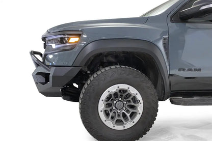 Fab Fours Matrix front bumper with pre-runner guard on a gray Ram 1500 TRX, close-up of the driver-side bumper corner, showing the pre-runner tube, end cap and wheel clearance