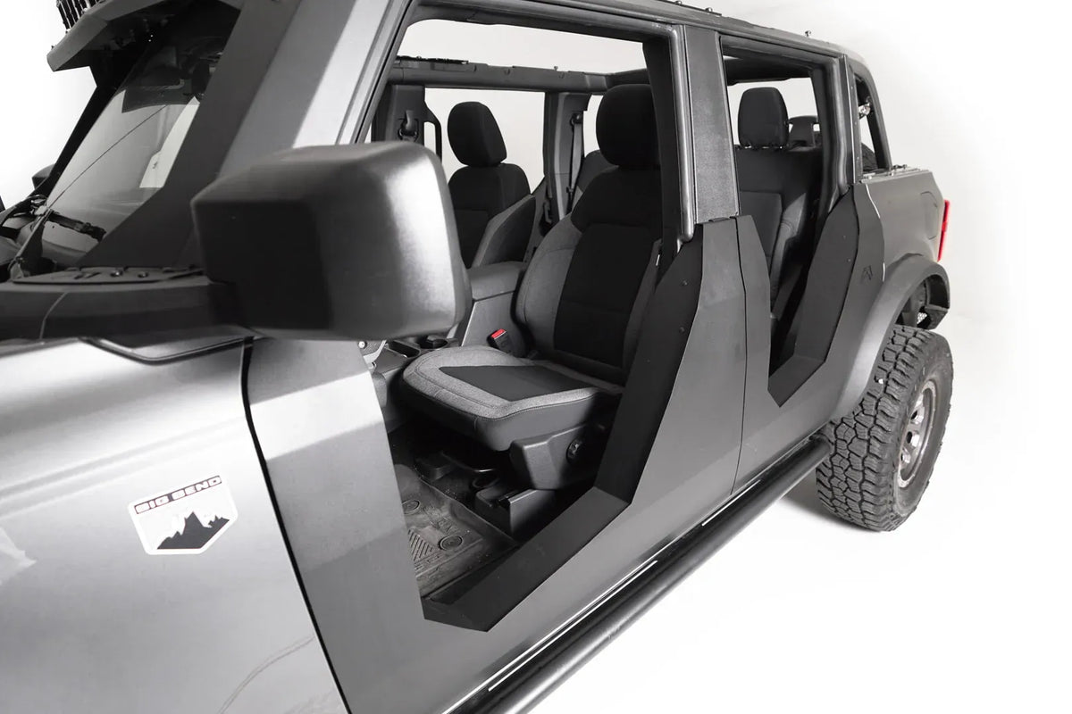 Close-up of Fab Fours Trail Doors on a gray Ford Bronco, driver side, showing the formed steel door edges and open view of the front seat