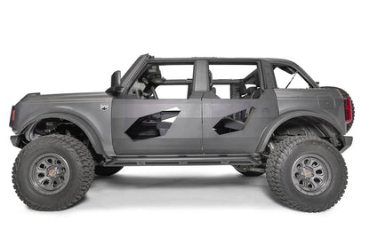 Fab Fours Trail Door Inserts on a gray four-door Ford Bronco, driver-side profile, showing the black steel inserts with angled window cutouts on the front and rear trail doors