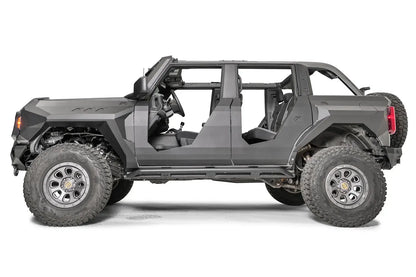 Fab Fours front and rear steel fenders on a lifted gray Ford Bronco with doors removed and Fab Fours body armor, driver-side profile view