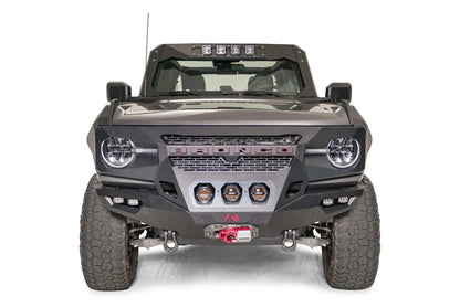 Fab Fours front steel fenders on a lifted gray Ford Bronco, front view, with Fab Fours winch bumper, amber pod lights, and cowl light bar