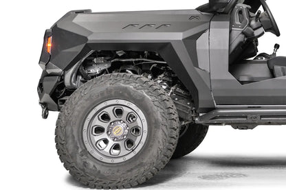 Fab Fours front steel fender with three vent cutouts and amber marker light on the driver side of a lifted gray Ford Bronco