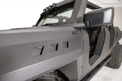 Close-up of the three vent cutouts and Fab Fours logo on a Fab Fours front steel fender on a gray Ford Bronco