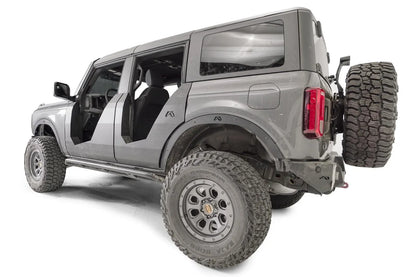 Fab Fours fender flares on a lifted gray Ford Bronco with doors removed, driver-side rear three-quarter view, showing rear flare with Fab Fours logo