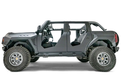 Fab Fours inner fenders on a lifted gray Ford Bronco with doors removed and Fab Fours body armor, driver-side profile view