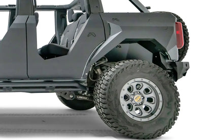 Fab Fours rear inner fender with Fab Fours logo in the driver-side rear wheel well of a lifted gray Ford Bronco with Fab Fours body armor