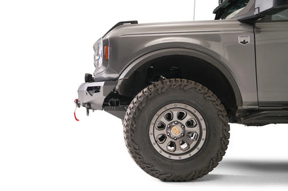 Fab Fours Lifestyle winch front bumper on a lifted gray Ford Bronco, driver-side profile view of the bumper end and front wheel