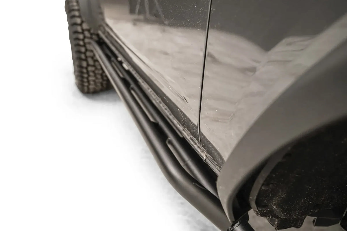 Close-up of the Fab Fours rock slider on a Ford Bronco, low passenger-side view