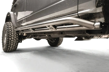 Fab Fours rock slider on a gray Ford Bronco, low driver-side view, showing the double-tube rail 