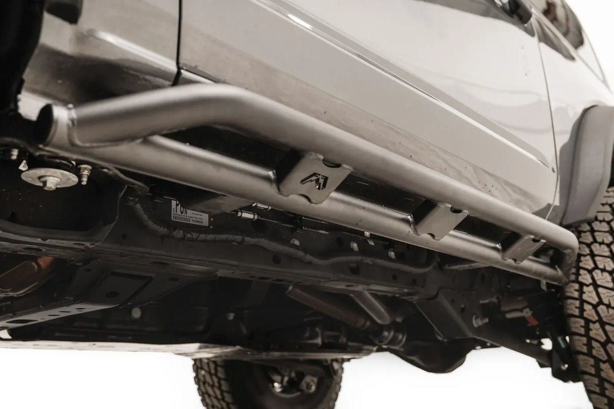 Underside view of the Fab Fours rock slider on a gray Ford Bronco