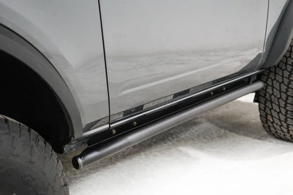 Close-up of the Fab Fours rock slider on a gray Ford Bronco, passenger side, showing the tube rail