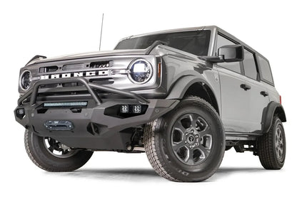 Fab Fours Matrix front bumper with pre-runner guard on a gray Ford Bronco, front driver-side three-quarter studio view, showing the pre-runner hoop, light bar and winch fairlead