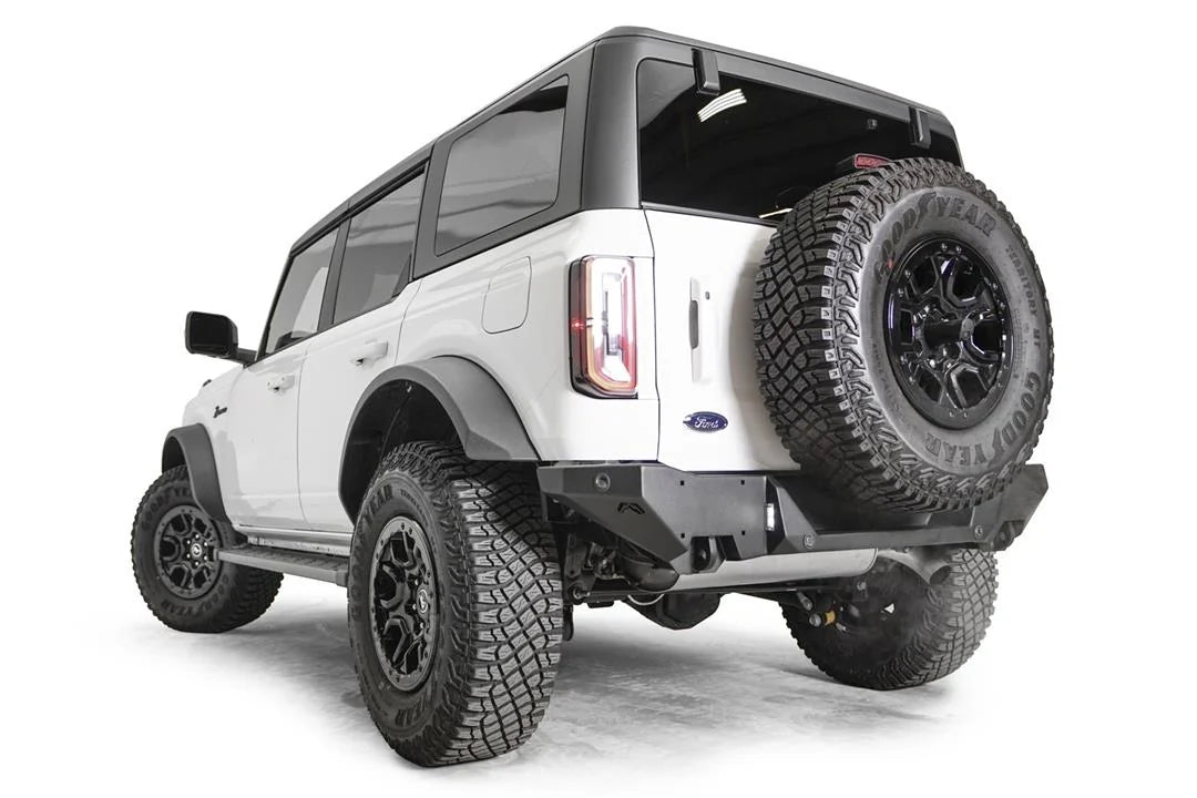 Fab Fours Premium rear bumper on a white Ford Bronco with tailgate-mounted spare tire, driver-side rear three-quarter view