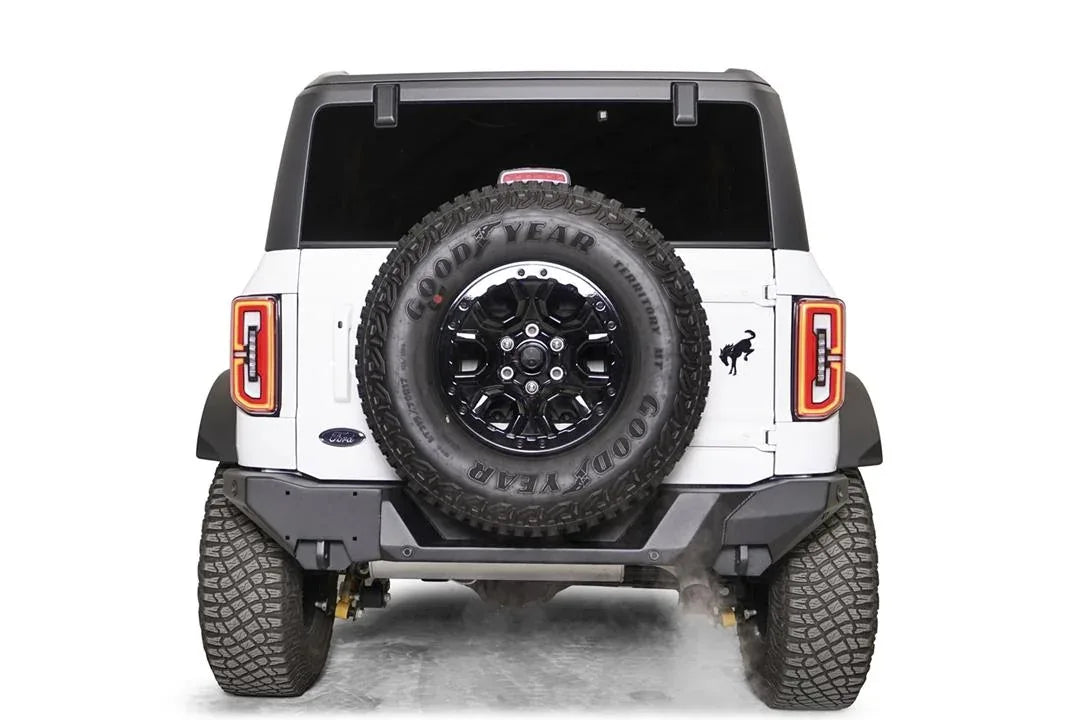 Fab Fours Premium rear bumper on a white Ford Bronco, straight rear view, with tailgate-mounted spare tire