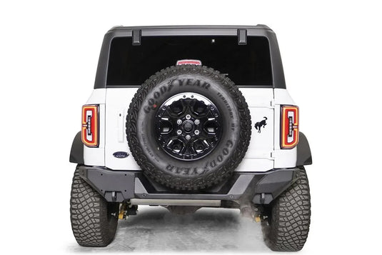 Fab Fours Premium rear bumper on a white Ford Bronco, straight rear view, with tailgate-mounted spare tire