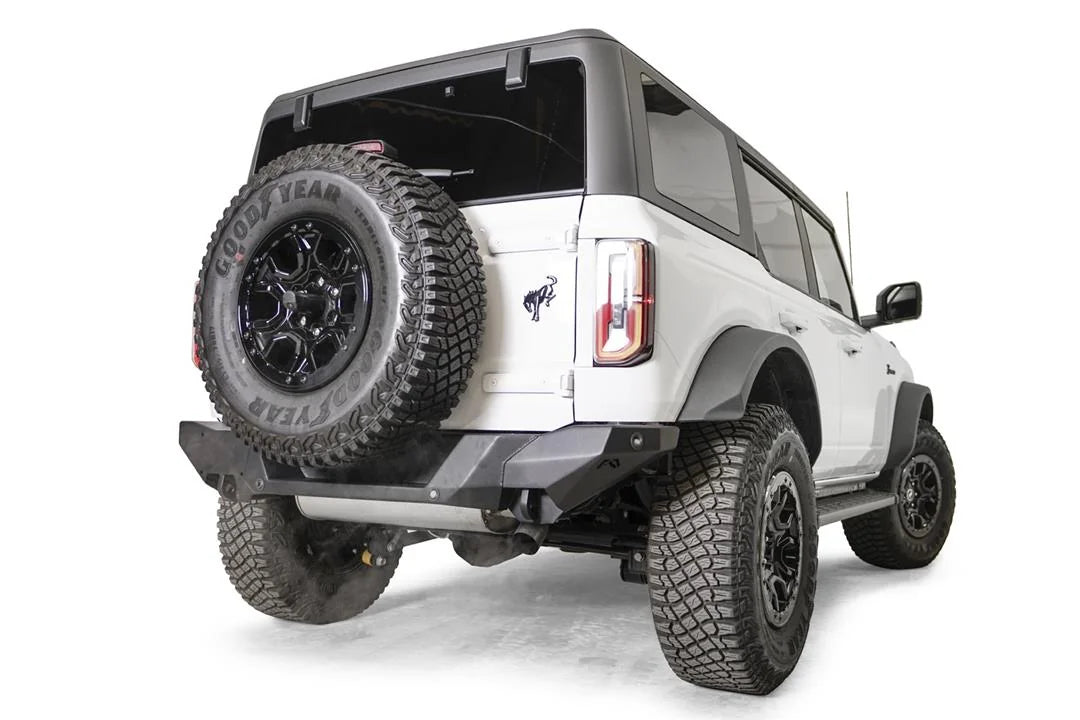 Fab Fours Premium rear bumper on a white Ford Bronco with tailgate-mounted spare tire, passenger-side rear three-quarter view