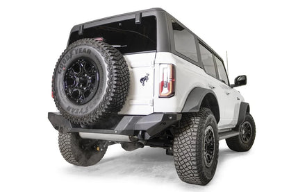 Fab Fours Premium rear bumper on a white Ford Bronco with tailgate-mounted spare tire, passenger-side rear three-quarter view