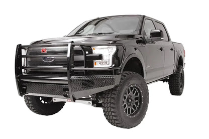 Fab Fours Black Steel front ranch bumper with full guard on a black Ford F-150, front driver-side three-quarter studio view, showing the full grille guard, diamond-plate bumper and wraparound wings
