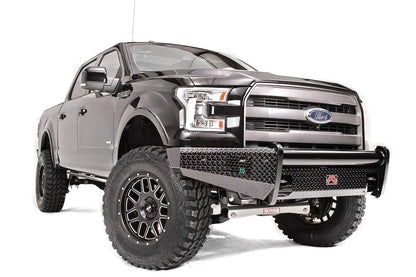 Fab Fours Black Steel front ranch bumper on a black Ford F-150, front passenger-side three-quarter studio view, showing the diamond-plate bumper face, tubular top rail and wraparound wings
