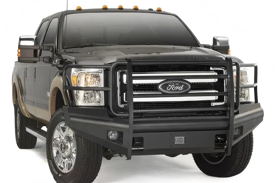 Fab Fours Black Steel Elite front bumper with full guard on a black two-tone Ford truck, front passenger-side three-quarter studio view, showing the full grille guard, smooth bumper face and fog lights