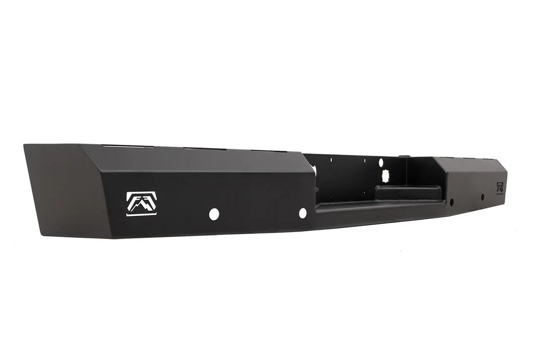 Fab Fours Red Steel rear bumper in black powder coat, angled view, showing the faceted end cap, logo cutout and recessed center section