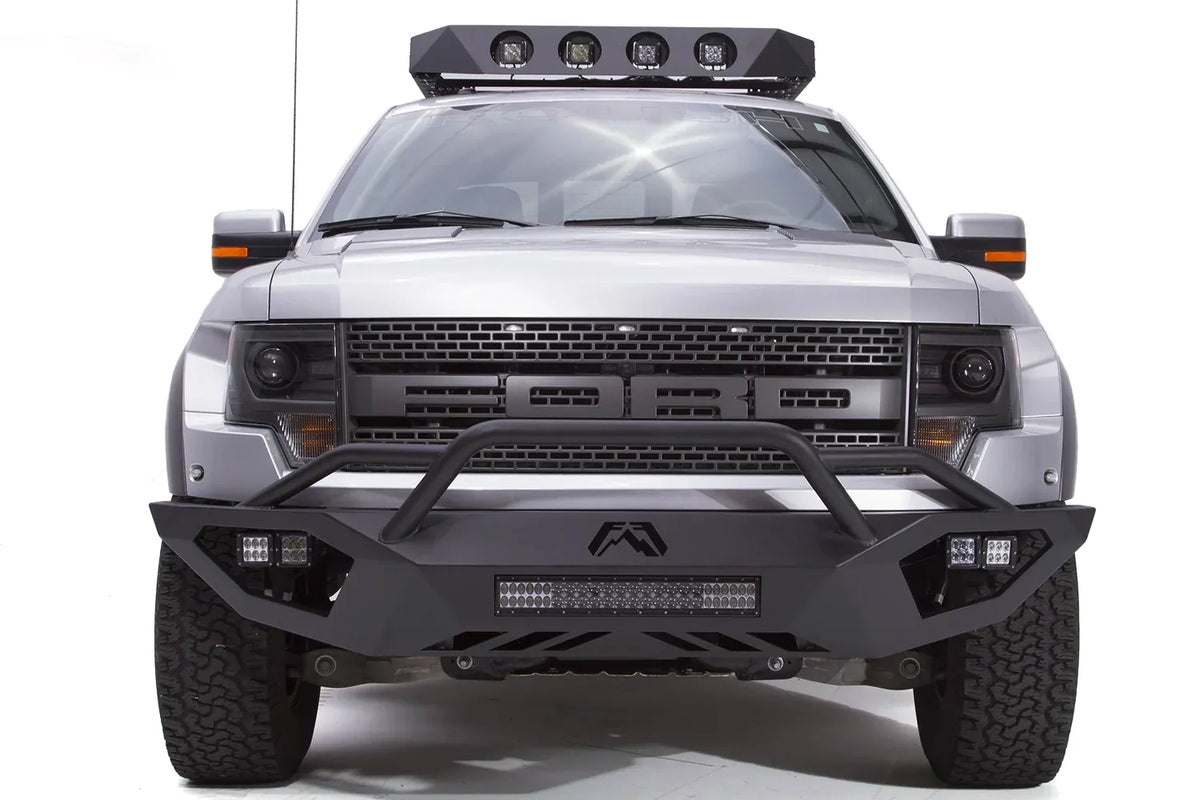 Fab Fours Vengeance front bumper with pre-runner guard on a silver Ford Raptor, straight-on front studio view, showing the pre-runner hoop, center light bar and cube light pods